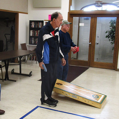 Waushara-Wautoma Senior Center two men playing corn hole