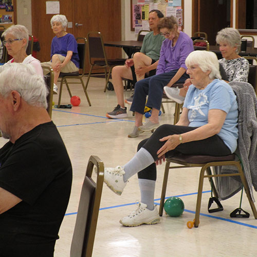 Waushara-Wautoma Senior Center several people doing leg exercises while seated