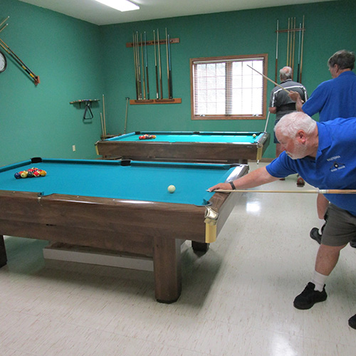 Three men playing pool
